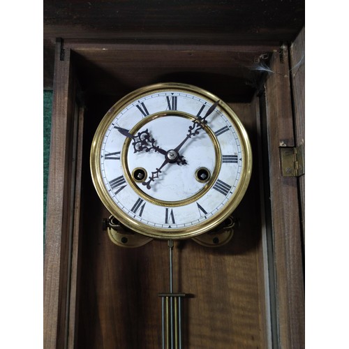 170 - A Vienna wall clock complete with pendulum key in working order, detailing to the top and base requi... 