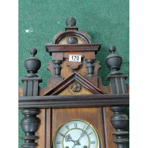 170 - A Vienna wall clock complete with pendulum key in working order, detailing to the top and base requi... 