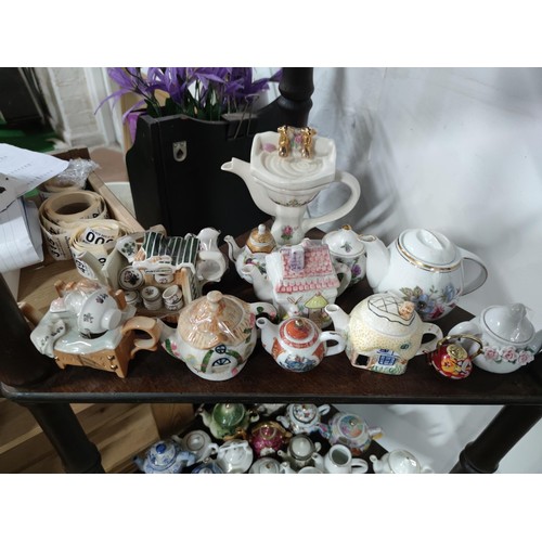 174 - A Large collection of 51 novelty ceramic teapots to include some rare models, a telephone box, post ... 