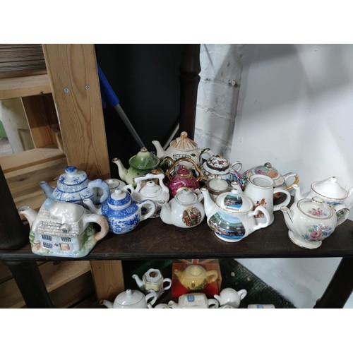 174 - A Large collection of 51 novelty ceramic teapots to include some rare models, a telephone box, post ... 