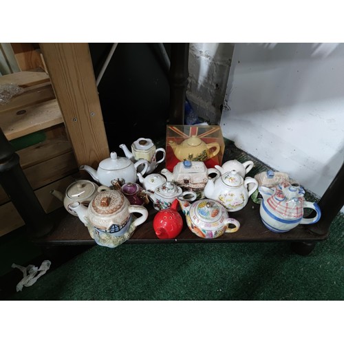 174 - A Large collection of 51 novelty ceramic teapots to include some rare models, a telephone box, post ... 