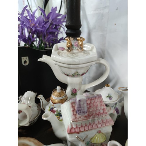 174 - A Large collection of 51 novelty ceramic teapots to include some rare models, a telephone box, post ... 