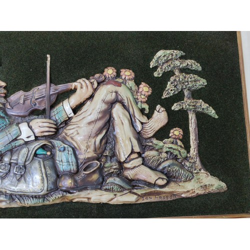 180 - A large Ian Fraser 3D depiction of a recumbent fiddler along with a framed 3D carving of wine makers... 