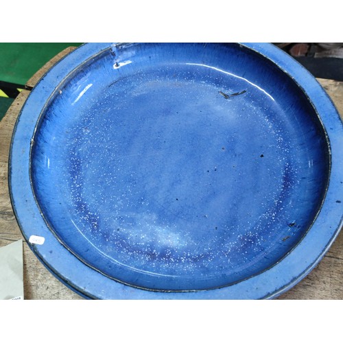 183 - A pair of blue terracotta large circular birdbaths largest has a diameter of 48cm.