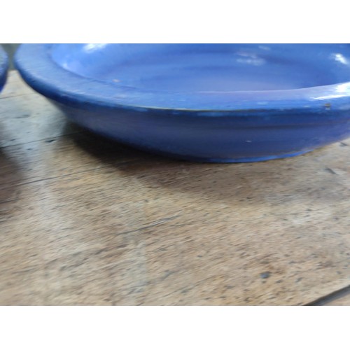 183 - A pair of blue terracotta large circular birdbaths largest has a diameter of 48cm.