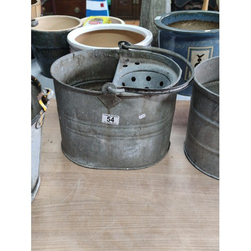 54 - A quantity of galvanized buckets including 2 mop buckets and 3 pales, one is marked Bemam 1952 with ... 