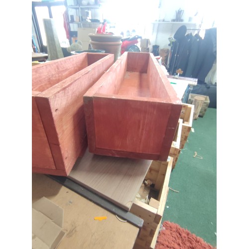 74 - 2 large wooden planters, 2 large elongated wooden planters, both been treated for outdoor use.
Longe... 