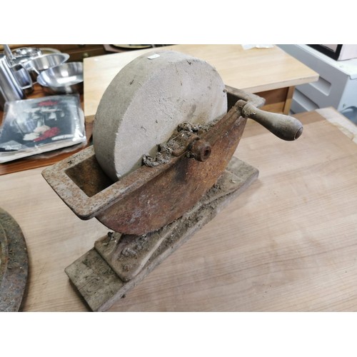 30 - Vintage grinding stone with wooden handle on wooden plinth along with a shoe last and a large cast i... 