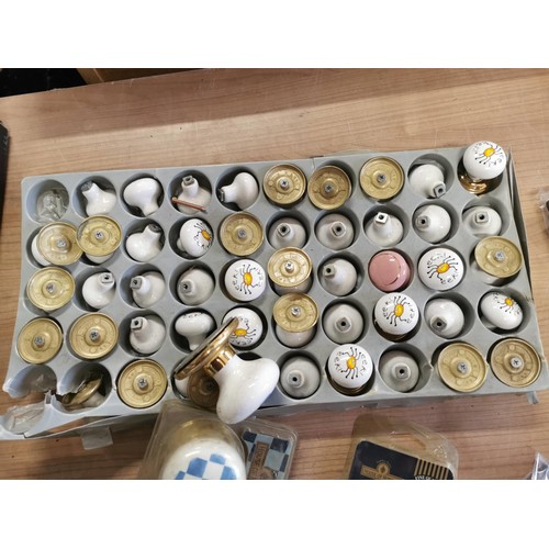 31 - Box containing a very large quantity of ceramic door knobs, some are sealed in original packing, alo... 