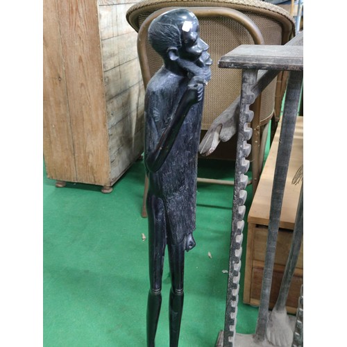 509 - A ethnic tall figure and a similar CD rack . the figure (76cm high is of heavy wood pos ebony