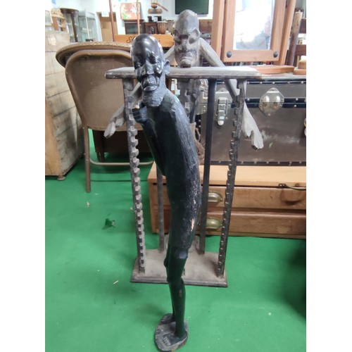 509 - A ethnic tall figure and a similar CD rack . the figure (76cm high is of heavy wood pos ebony