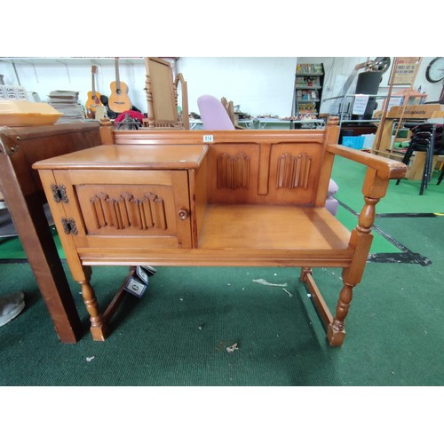 514 - Linen fold oak effect telephone seat with a cupboard to left in good condition