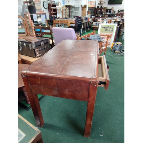 515 - Leather covered desk with two drawers and studded corner reinforcements. Drawers operate of metal ru... 