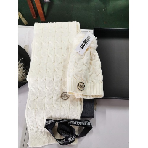 123 - Boxed UGG wool scraf and bobble hat set retailed by Selfridges both pieces have UGG metal labels att... 