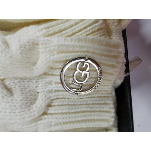 123 - Boxed UGG wool scraf and bobble hat set retailed by Selfridges both pieces have UGG metal labels att... 