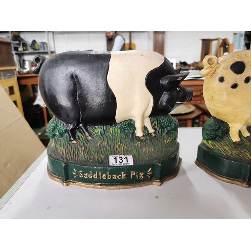 131 - 2x large cast iron pig formed door stops inc Gloucestershire pig and a Saddleback pig. height of 22c... 