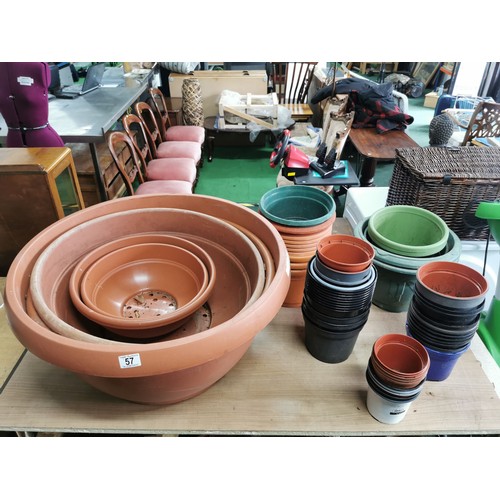 57 - Large collection of plastic planters of varying sizes all in good order, largest one measures 70cm d... 