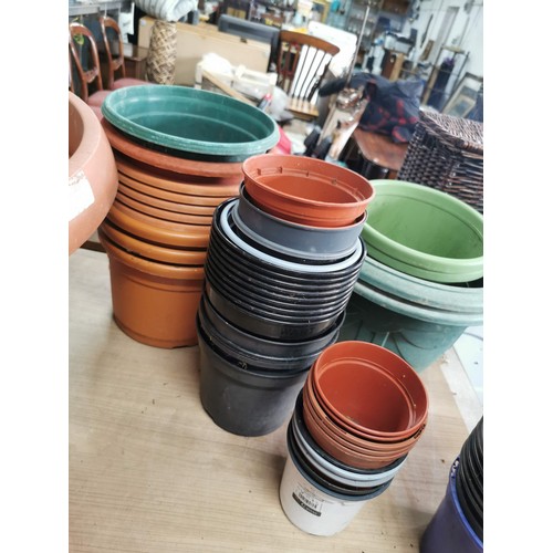 57 - Large collection of plastic planters of varying sizes all in good order, largest one measures 70cm d... 