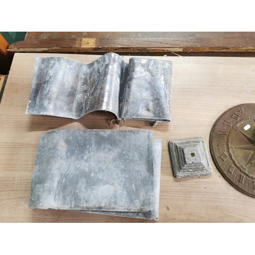 61 - Collection of lead sheets folded up along with a brass sundial, sundial has a diameter of  28cm