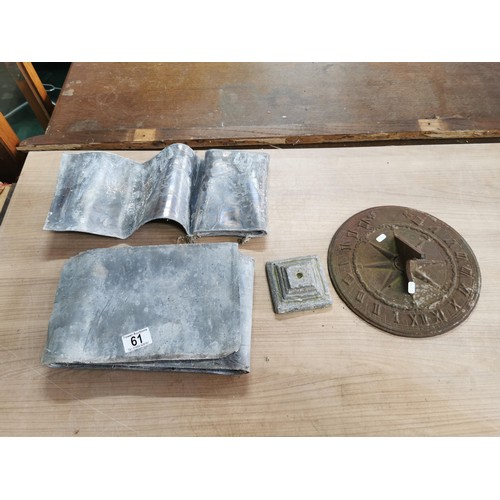61 - Collection of lead sheets folded up along with a brass sundial, sundial has a diameter of  28cm