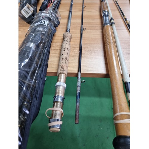 208 - A large quantity of various fishing rods and 2 fishing reels fitted in a good quality fishing rod ba... 