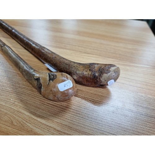 210 - 2x vintage handmade wooden walking sticks with knobkerry style tops. Tallest stick has a height of 8... 