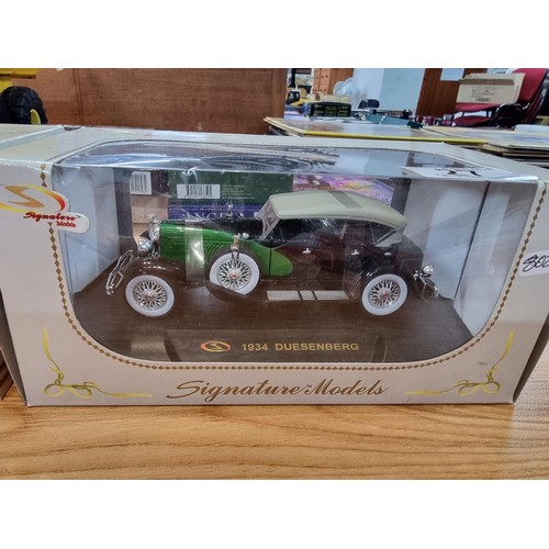 27 - A quantity of diecast vehicles including 2 boxed signature models vintage diecast cars along with 3 ... 