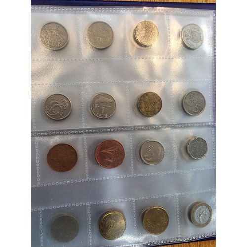 29 - A comprehensive coin album full of various world coins along with an as new handy fold flat fabricat... 