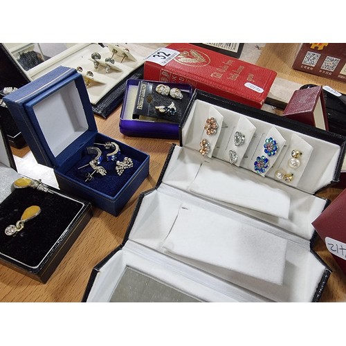 32 - A large collection of various boxed costume jewellery including 2 good dress rings, many pairs of ea... 