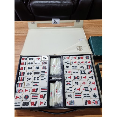 50 - A good quality complete Mahjongg game set by dragon, comes along with a boxed set of wracks for Mahj... 