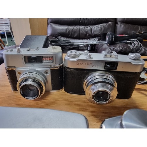 54 - A large collection of 12 various vintage cameras to include rangefinder cameras along with a large q... 