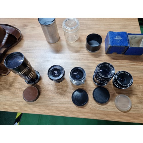 57 - A quantity of vintage cameras and lenses to include  a Praktina FX 35mm camera fitted with a Carl Ze... 