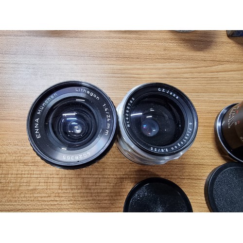 57 - A quantity of vintage cameras and lenses to include  a Praktina FX 35mm camera fitted with a Carl Ze... 