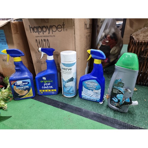 63 - A box of odds to include a good set of artificial flowers a large quantity of pest control sprays (m... 