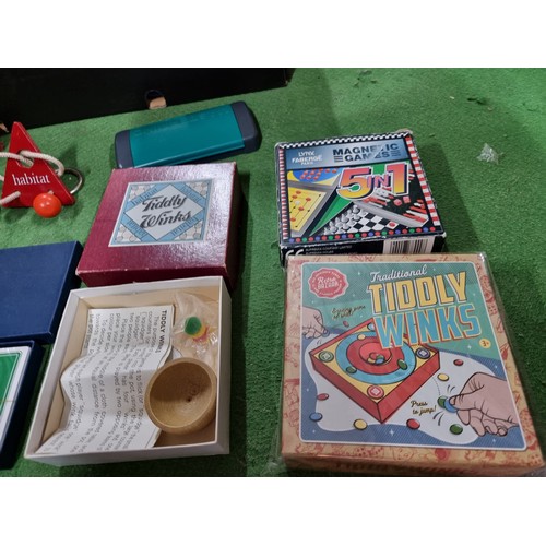 75 - A box of various board games including tiddly winks, cribbage, etc.