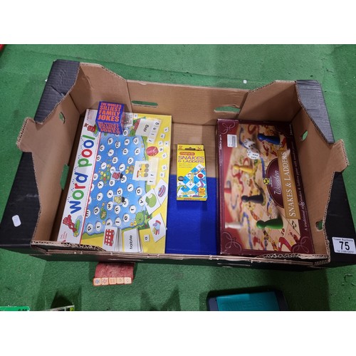 75 - A box of various board games including tiddly winks, cribbage, etc.