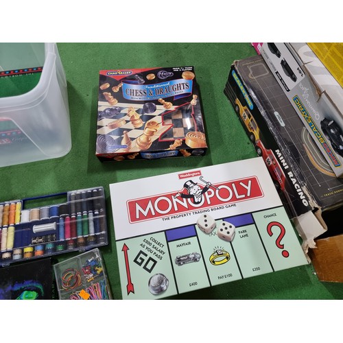 76 - A box full of various board games and a boxed 99 piece toolkit in a car formed case, to include mono... 