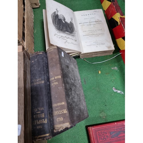 83 - A large quantity in 4 boxes of mostly antique books to include many religious Books, bible, etc, alo... 