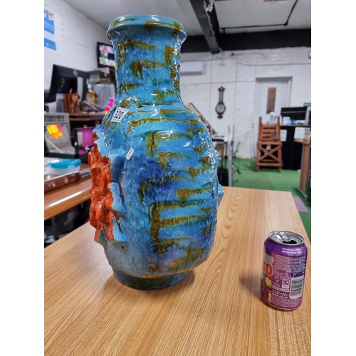 320 - A very large unusual West German glazed jug vase in blue and green with an orange flower design to t... 