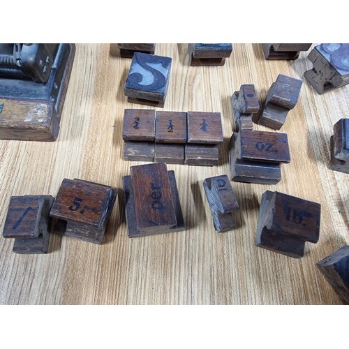 322 - A large quantity of various vintage printing blocks mostly of letters and numbers along with fractio... 