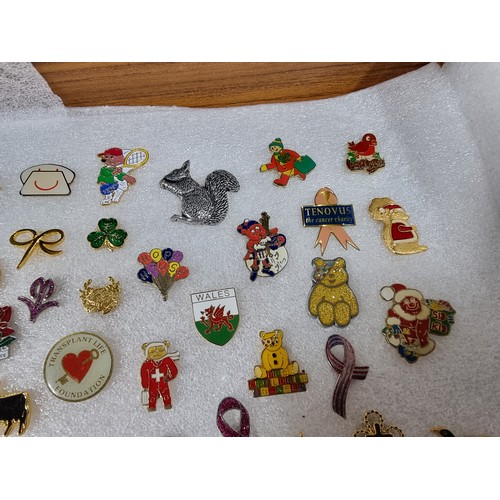 327 - A very large collection of over 100x various pin brooches covering various subjects including Mickey... 