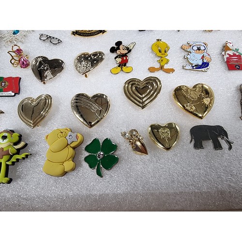 327 - A very large collection of over 100x various pin brooches covering various subjects including Mickey... 