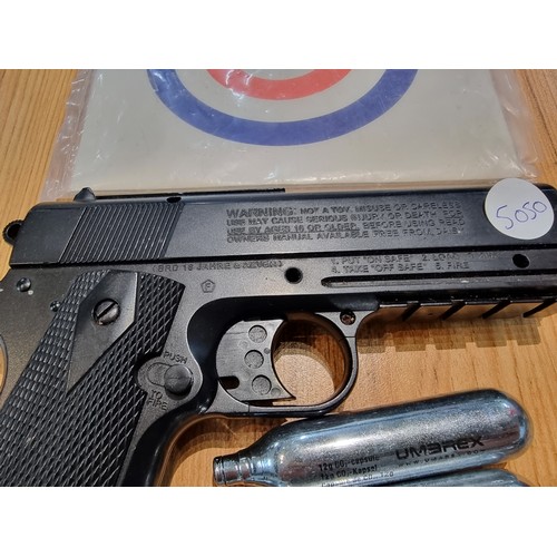 331 - A .177 gas powered BB gun by powerline Japan in good condition with targets and metal BB's included.