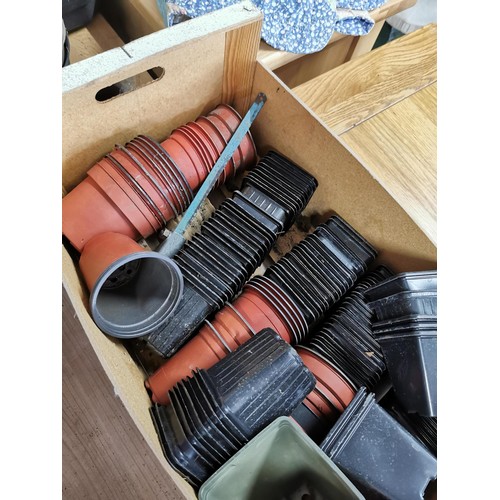 240 - Large quantity of plastic plant pots inc trug of plant pots, box of pots and bag of pots.