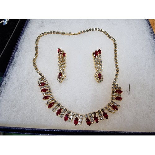 337 - A large quantity of boxed unused matching costume jewellery sets to include a pretty red and clear s... 