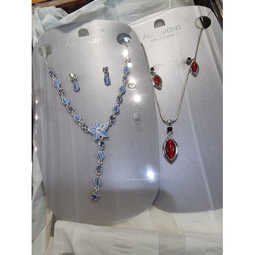 337 - A large quantity of boxed unused matching costume jewellery sets to include a pretty red and clear s... 