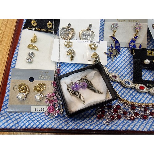 341 - A large quantity of various as new costume jewellery includes mostly earrings along with some bracel... 