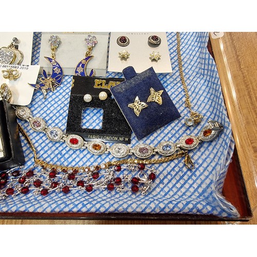 341 - A large quantity of various as new costume jewellery includes mostly earrings along with some bracel... 