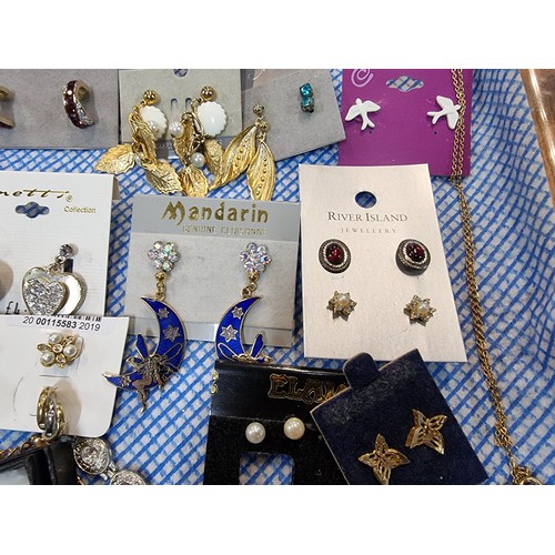 341 - A large quantity of various as new costume jewellery includes mostly earrings along with some bracel... 