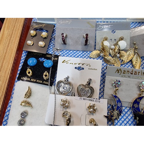 341 - A large quantity of various as new costume jewellery includes mostly earrings along with some bracel... 